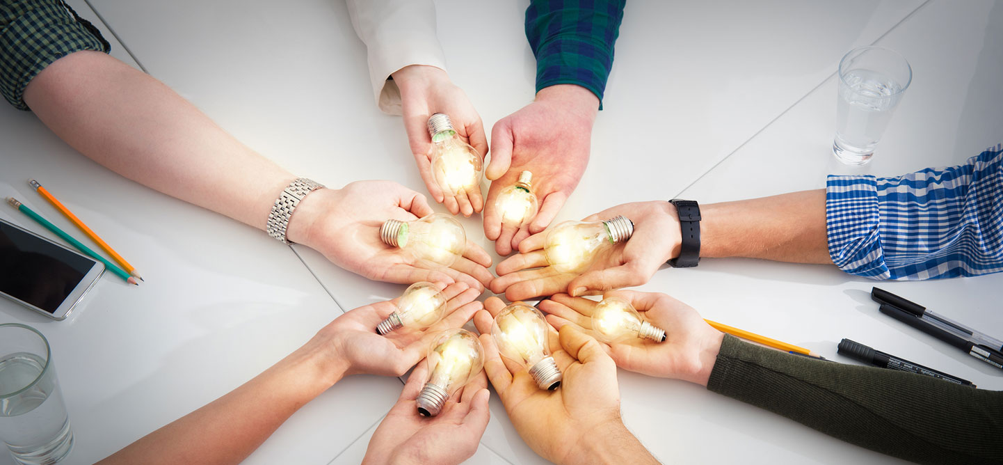 Strategic Brands hands holding light bulbs